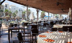 阿尔梅利马AR阿尔梅里玛尔酒店的一个带桌椅和遮阳伞的用餐区