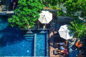 芭东海滩Mazi Design Hotel by Kalima - SHA Plus的享有带遮阳伞的游泳池的顶部景致
