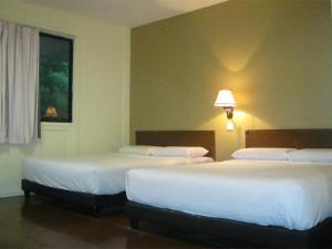 珍拉丁伊斯塔纳珍拉汀海滩度假村的酒店客房设有两张床和窗户。