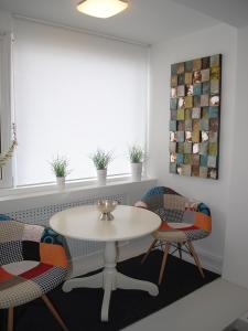 蒂米什瓦拉The Kiss Apartment的客房设有桌椅和窗户。