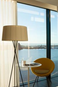 利物浦利物浦普尔曼酒店的窗户房间里一张桌子和一把椅子