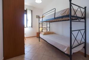 阿尔盖罗Elena House的一间卧室配有两张双层床。