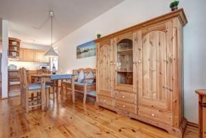 赛巴特班森Haus Rolandseck - FeWo 03的一间厨房和带大型木制橱柜的用餐室