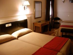 昆卡卡诺瓦斯旅馆的酒店客房配有一张床铺和一张桌子。