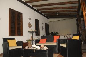 圣维托罗卡波Kimos的客厅配有椅子和一张带彩色枕头的桌子