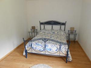 Saint-Jean-le-VieuxDomaine Harrieta的卧室配有蓝色和白色的床和两张桌子