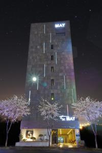 光州五月酒店的一座高大的建筑,晚上有标志