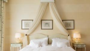 苏尔扎诺利瓦拉戈酒店的卧室配有带白色枕头的天蓬床