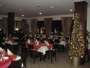 布利斯卡斯特尔Bliestal Hotel的用餐室配有桌子和圣诞树
