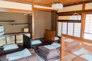 轻井泽高野背包客旅馆的带两张双层床和两扇窗户的房间
