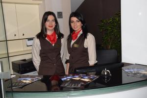 萨拉热窝Hotel Elegance的两个女人站在桌子旁边
