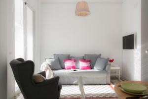 瓦伦西亚Apartments Carmen III的客厅配有粉红色枕头的沙发
