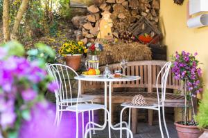 巴特布雷希格Hotel Fontana - ADULTS ONLY的鲜花庭院里的桌椅