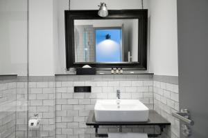 曼海姆Staytion Urban City Hotel Mannheim的白色的浴室设有水槽和镜子
