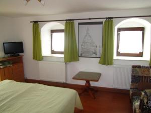 施托尔彭兰德斯特莱豪斯公寓的一间卧室配有床和两个带绿色窗帘的窗户。