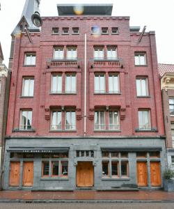 阿姆斯特丹班克酒店的一座古老的红砖建筑,设有橙色门