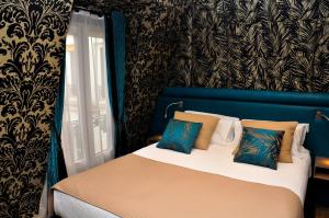 巴黎Hôtel du Mont Blanc的一间卧室配有一张蓝色和黑色墙壁的床