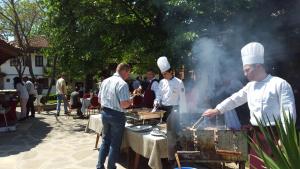 斯利文Bozukova House的一组厨师在烧烤架上烹饪食物