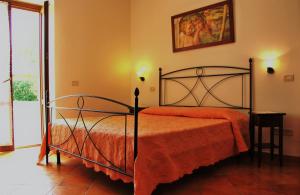 马萨马里蒂马Agrisantanna的一间卧室配有一张带橙色毯子的床