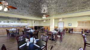 默特尔比奇North Shore Oceanfront Resort Hotel的一间带桌椅的用餐室和一间酒吧