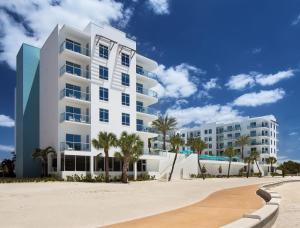 圣徒皮特海滩金银岛度假村的海滩上一座白色公寓大楼,种植了棕榈树