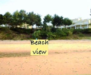 特罗亚Troia Apartments的海滩上的一个标志,海滩景