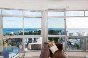 萨尔瓦多Luxury Surround Sea View Apartment的带沙发和大窗户的客厅