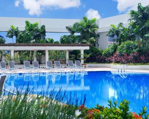 莎阿南莎亚南凯煌大酒店的一座带椅子的游泳池以及一座建筑