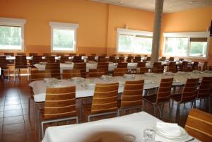 ArlanzónBungalows Granja Escuela Arlanzón的大型用餐室配有桌椅