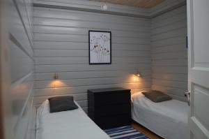 塔库沃里Tahkonranta的配有白色墙壁的小客房内的两张床