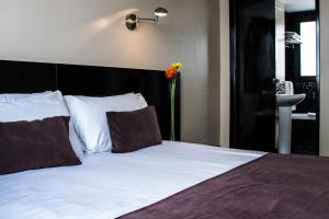 Épico Recoleta Hotel客房内的一张或多张床位