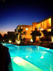 干尼亚罗登酒店的大楼前的大型蓝色游泳池