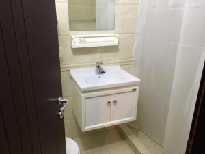 斯特鲁加Hotel Prestige Struga的浴室设有白色水槽和镜子
