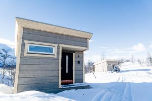 Nikkaluokta伊诺克斯拉迪加夫瑞山林小屋的雪中的小房子,门打开了