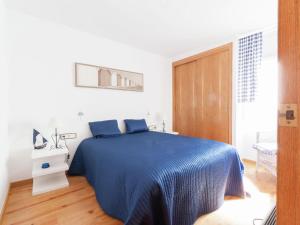 莱斯卡拉Belvilla by OYO Albatros 6的一间白色客房内的蓝色床卧室