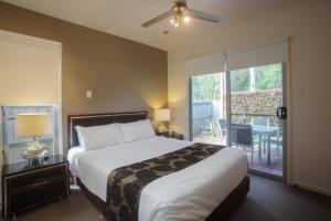 赫维湾Quarterdecks Retreat的一间卧室设有一张大床和一个大窗户