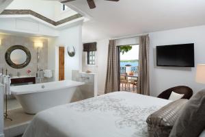 新士麦那海滩Black Dolphin Inn的白色的浴室设有浴缸和床。