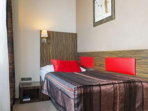 布拉格EA水晶宫酒店的配有红色枕头的床的酒店客房