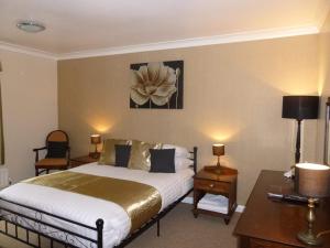 阿什伯顿达特穆尔洛奇酒店 的酒店客房配有一张床、一张桌子和一张桌子。