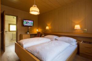 科尔福索埃里卡旅馆的一间卧室设有一张大床,内配电视