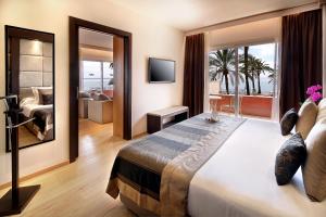 伊利塔斯Palace Bonanza Playa Resort & SPA by Olivia Hotels Collection的一间带大床的卧室和一间客厅