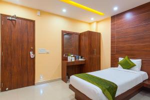 加尔各答Treebo Trend Globe International的一间卧室配有一张床和一扇木门