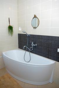 萨基爱伊森特拉斯酒店的浴室设有白色浴缸及镜子