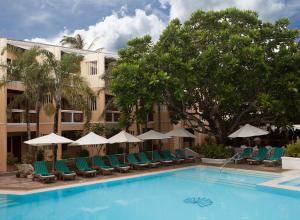 长滩岛赫纳恩丽景湾spa酒店的酒店设有带椅子和遮阳伞的游泳池