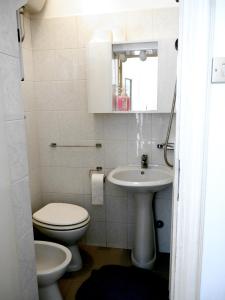滨海波利尼亚诺La Conchiglia Domus的白色的浴室设有卫生间和水槽。