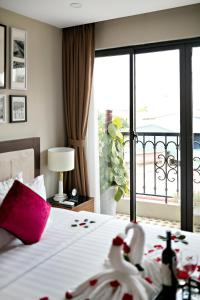 河内金月亮套房酒店 的酒店客房设有一张床铺,享有阳台的景色