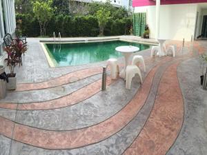 大城瓦萨纳设计酒店的大楼前的带桌椅的游泳池