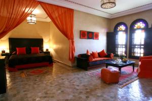 马拉喀什阿尔法希亚阿古达尔酒店的客厅配有床和沙发
