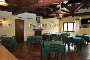Monte San PietrangeliAgriturismo Oasi Belvedere的用餐室配有绿色的桌椅
