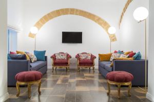 马尔萨拉维亚可文图公寓的带沙发和椅子的客厅以及电视